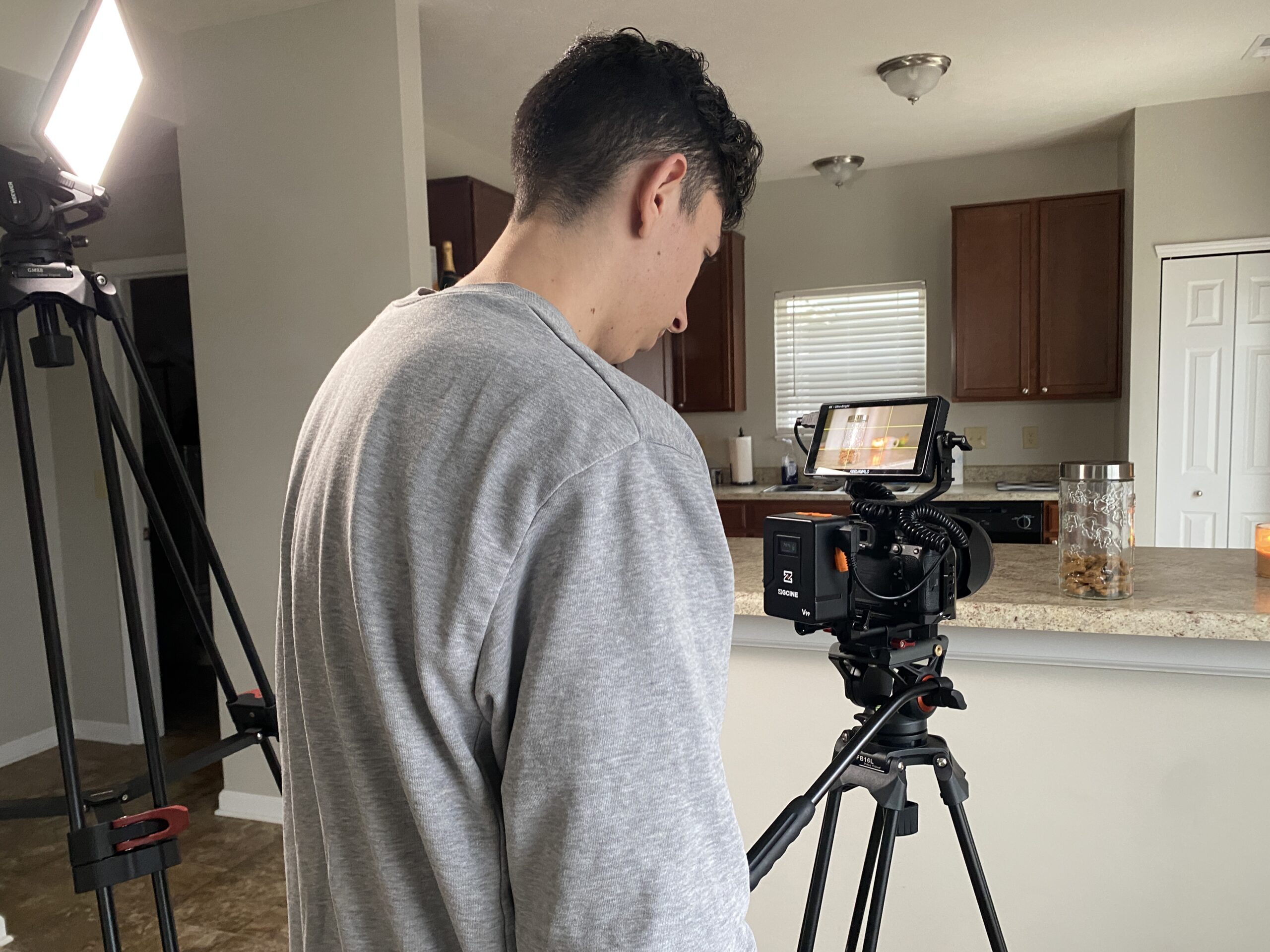 Behind the scenes photo of cameraman taking photo of kitchen